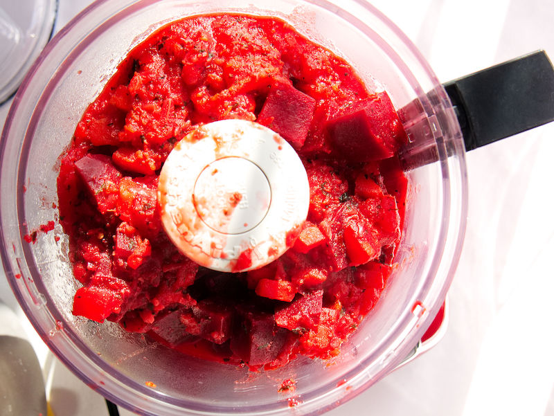 Red Beauty Vegetable Sauce after cooking in the electric pressure cooker being blended in a food processor. 